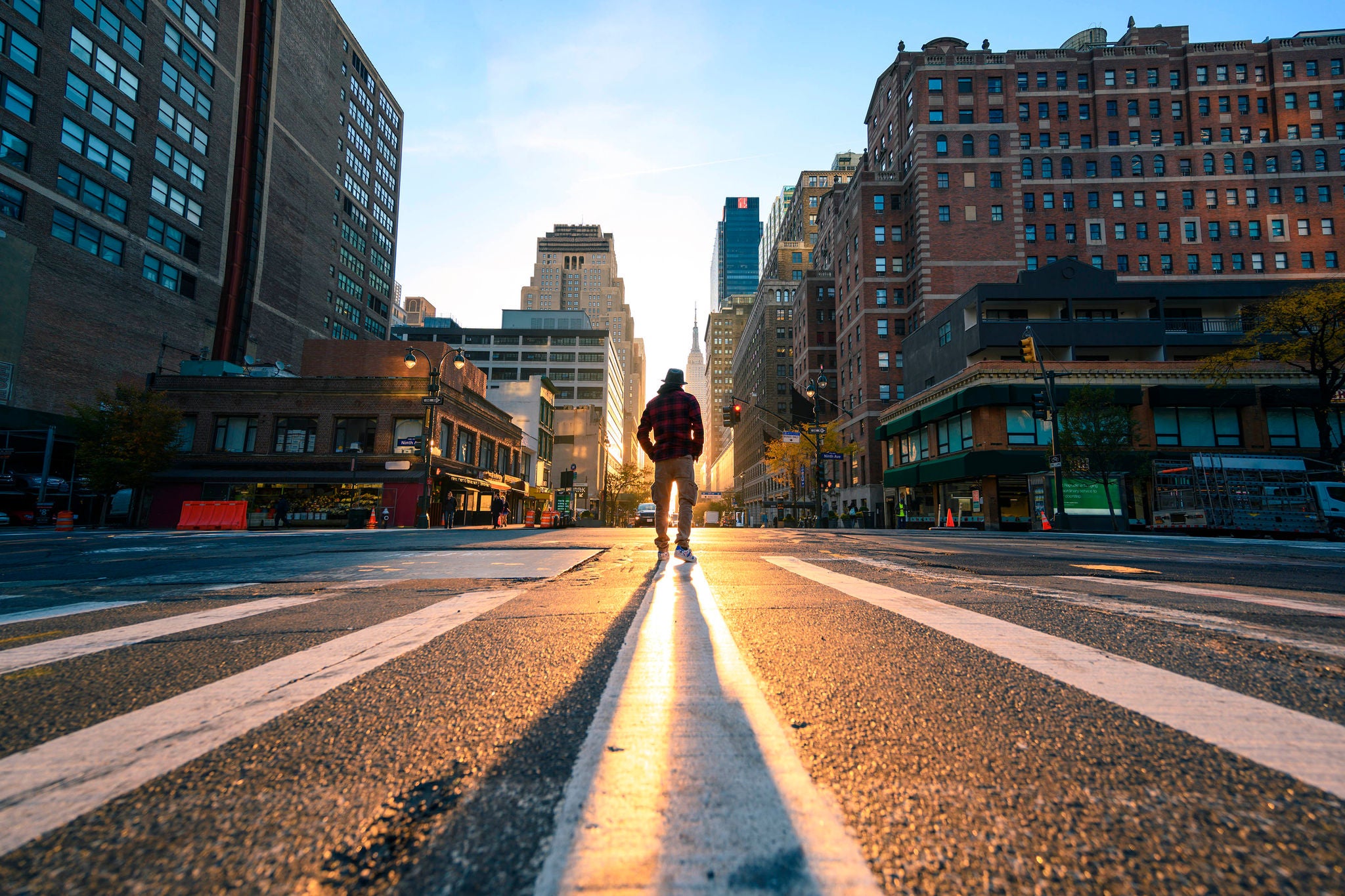 One person crossing a junction in Manhattan at sunrise, New York City, One person crossing a junction in Manhattan at sunrise, New York